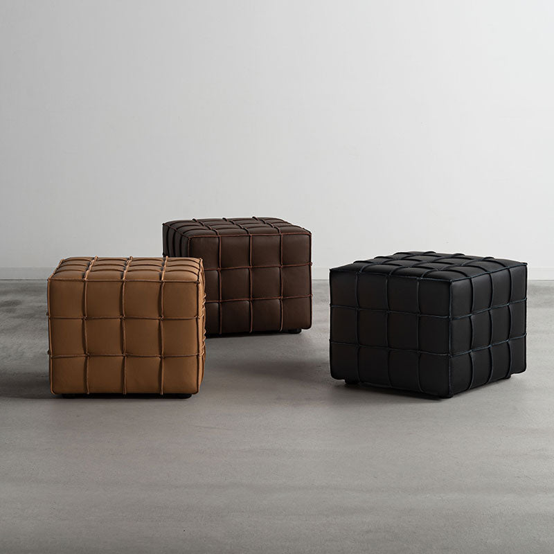 本革を繋ぎ合わせブロックチェックのようなデザインを施したキューブ型スツール
